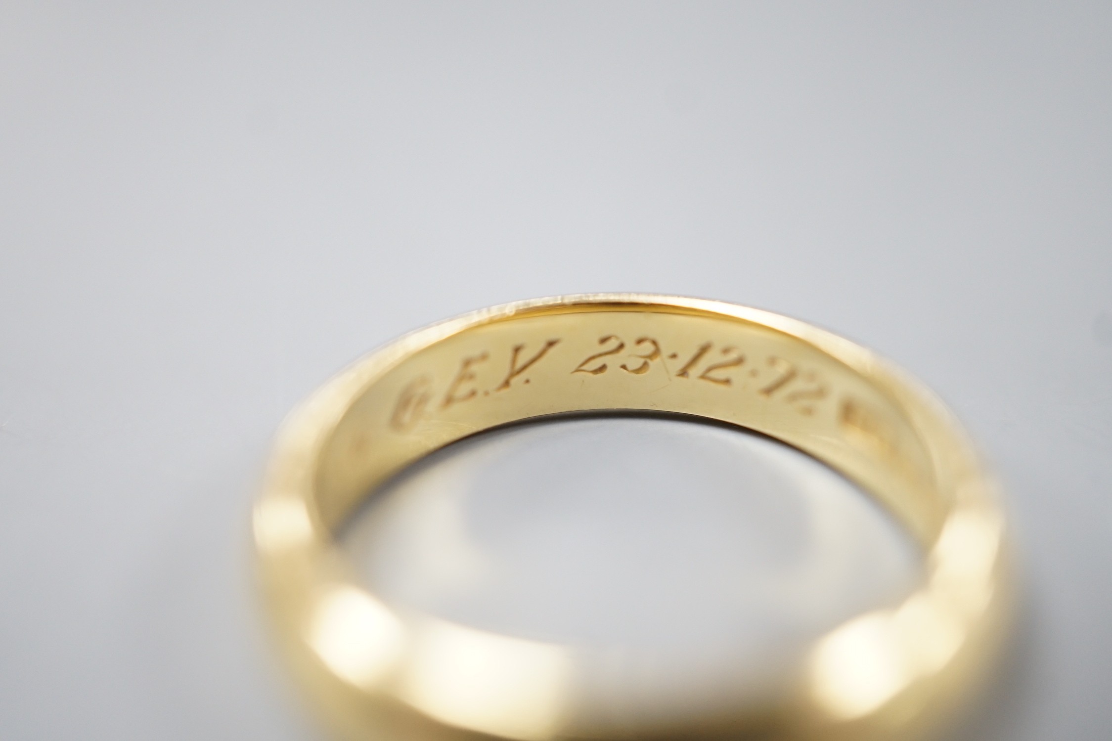 A 1970's 18ct gold wedding band, with engraved inscription, size O/P, 6.7 grams.